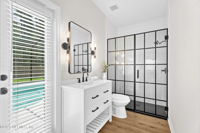 1008 Durbin Parke Dr, Saint Johns, FL 32259 - bathroom with vanity, wood finished floors, toilet, and a shower