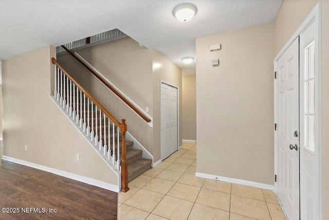 1147 Hyacinth St, Saint Augustine, FL 32092 - entrance foyer with stairs, a textured ceiling, baseboards, and tile patterned flooring