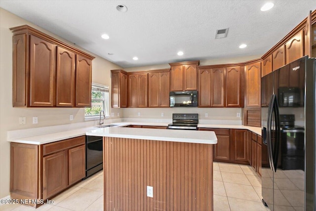 1147 Hyacinth St, Saint Augustine, FL 32092 - kitchen with black appliances, a sink, light tile patterned floors, a center island, and recessed lighting