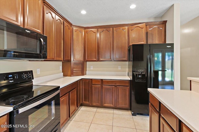 1147 Hyacinth St, Saint Augustine, FL 32092 - kitchen with black appliances, light countertops, light tile patterned floors, a textured ceiling, and brown cabinets