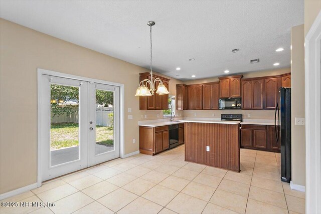 1147 Hyacinth St, Saint Augustine, FL 32092 - kitchen with black appliances, a sink, baseboards, light countertops, and a kitchen island