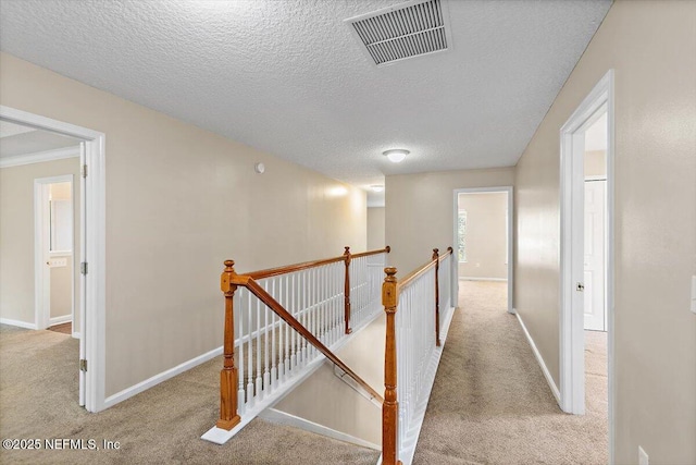 1147 Hyacinth St, Saint Augustine, FL 32092 - hallway featuring an upstairs landing, carpet floors, a textured ceiling, and baseboards