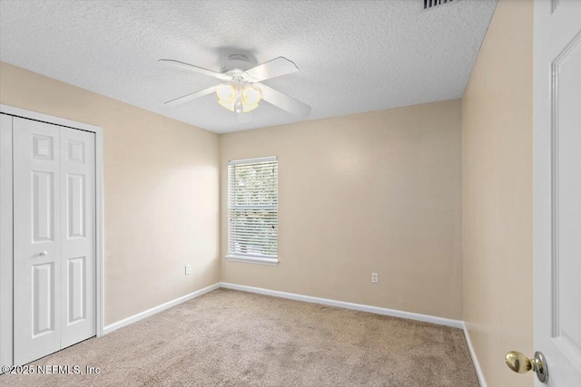 1147 Hyacinth St, Saint Augustine, FL 32092 - unfurnished bedroom with carpet floors, a closet, baseboards, a textured ceiling, and a ceiling fan