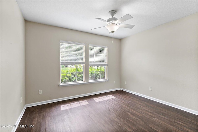4952 Cypress Links Blvd, Elkton, FL 32033 - unfurnished room featuring dark wood finished floors, baseboards, and a ceiling fan