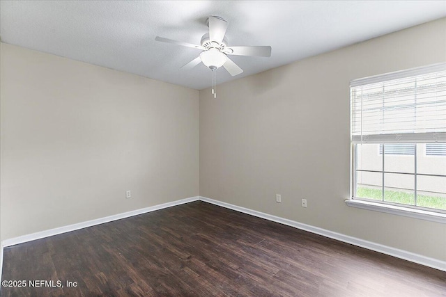 4952 Cypress Links Blvd, Elkton, FL 32033 - empty room featuring dark wood finished floors, baseboards, and a ceiling fan