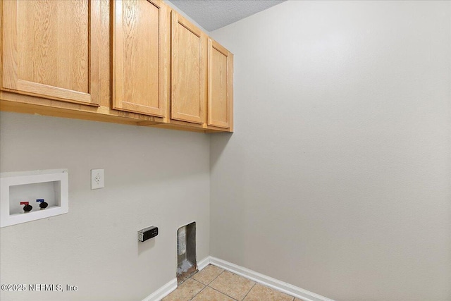 4952 Cypress Links Blvd, Elkton, FL 32033 - laundry room featuring cabinet space, hookup for a washing machine, baseboards, and light tile patterned floors