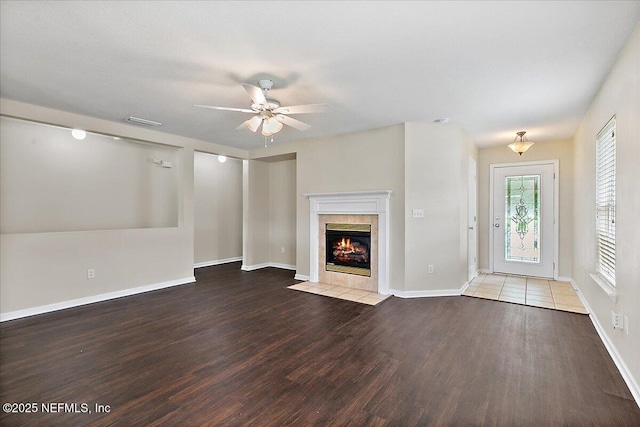 4952 Cypress Links Blvd, Elkton, FL 32033 - unfurnished living room with wood finished floors, a fireplace, ceiling fan, and baseboards