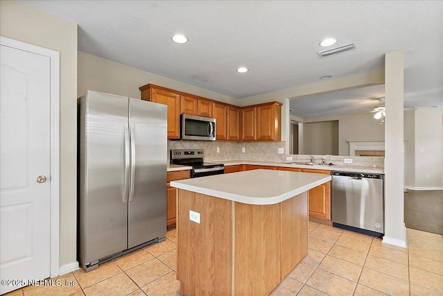 4952 Cypress Links Blvd, Elkton, FL 32033 - kitchen featuring stainless steel appliances, a sink, light tile patterned flooring, decorative backsplash, and light countertops