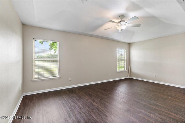 4952 Cypress Links Blvd, Elkton, FL 32033 - empty room featuring plenty of natural light, dark wood finished floors, and a ceiling fan