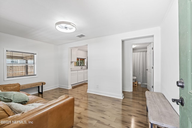 9160 Wild Rd, Jacksonville, FL 32220 - living area with light wood-style floors, baseboards, and ornamental molding