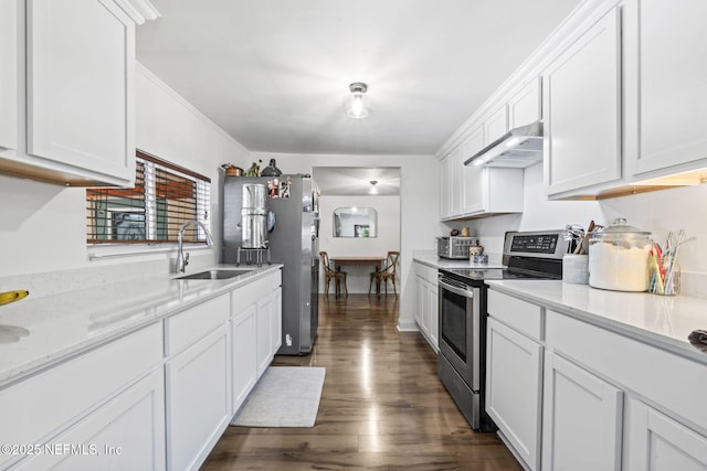 9160 Wild Rd, Jacksonville, FL 32220 - kitchen with stainless steel appliances, a sink, under cabinet range hood, white cabinetry, and dark wood finished floors