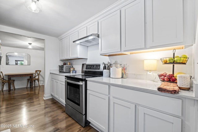 9160 Wild Rd, Jacksonville, FL 32220 - kitchen featuring stainless steel range with electric stovetop, under cabinet range hood, white cabinetry, light countertops, and dark wood-style floors