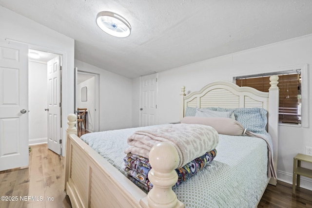 9160 Wild Rd, Jacksonville, FL 32220 - bedroom featuring wood finished floors, vaulted ceiling, and a textured ceiling