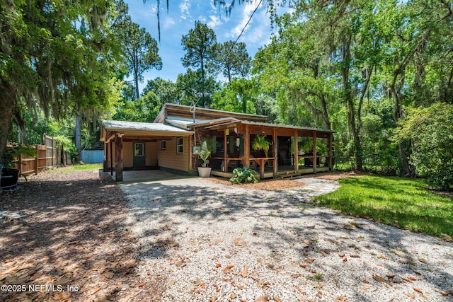 9160 Wild Rd, Jacksonville, FL 32220 - rustic home with a carport, driveway, and metal roof