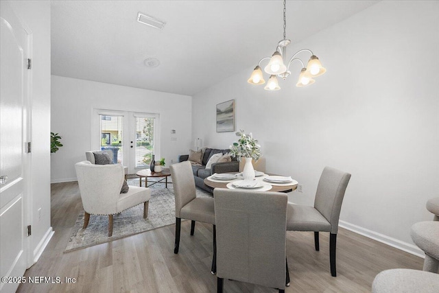 650 Drake Bay Ter, Saint Augustine, FL 32084 - dining space featuring wood finished floors, a chandelier, baseboards, and lofted ceiling