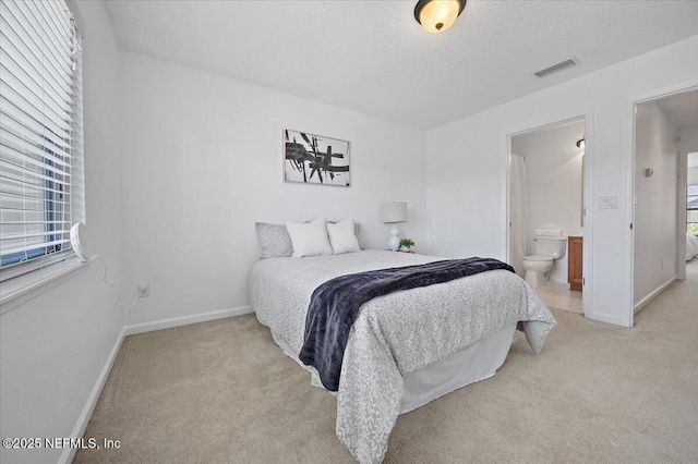 650 Drake Bay Ter, Saint Augustine, FL 32084 - bedroom featuring light carpet, baseboards, ensuite bathroom, and a textured ceiling