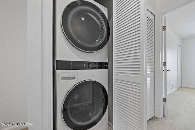650 Drake Bay Ter, Saint Augustine, FL 32084 - washroom featuring stacked washer / drying machine, carpet flooring, and baseboards