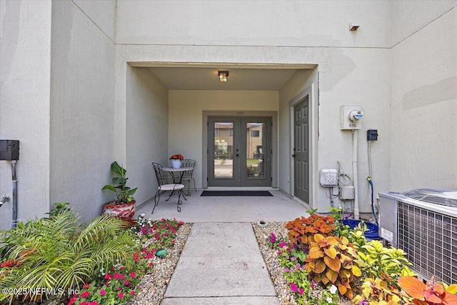 650 Drake Bay Ter, Saint Augustine, FL 32084 - entrance to property with french doors, central air condition unit, and stucco siding