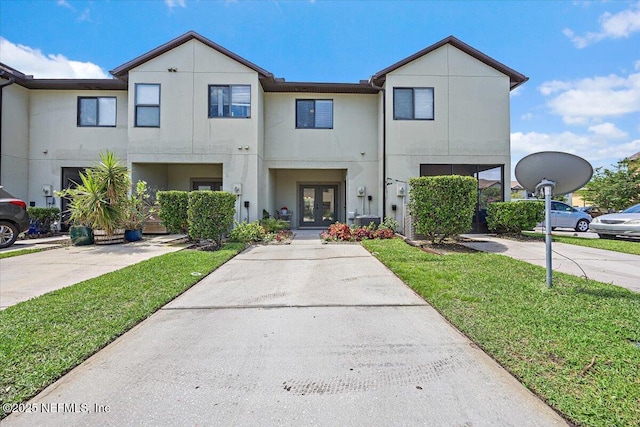 650 Drake Bay Ter, Saint Augustine, FL 32084 - view of property featuring french doors, a front yard, and stucco siding
