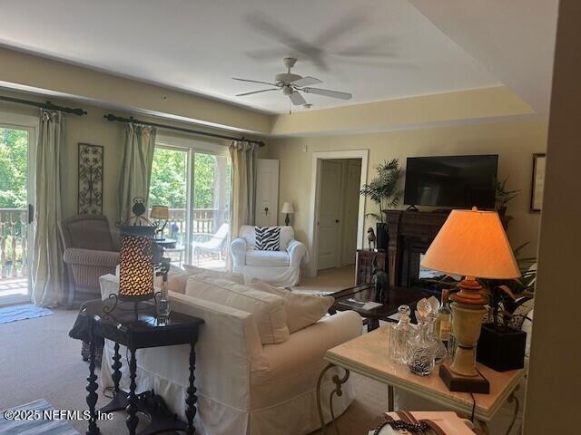 955 Registry Blvd Unit 229, Saint Augustine, FL 32092 - carpeted living area with a ceiling fan, a fireplace, and a tray ceiling