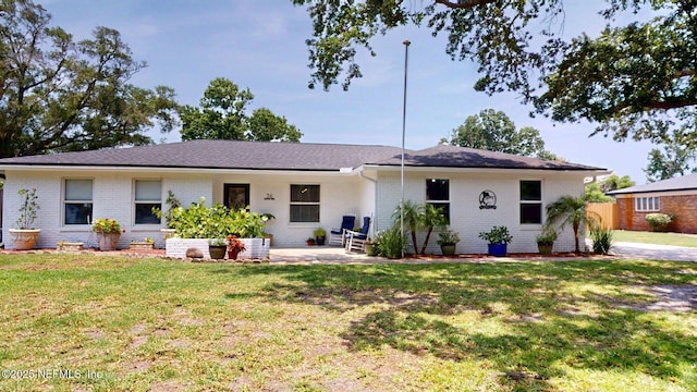 26 Sailfish Dr, Ponte Vedra Beach, FL 32082 - ranch-style house with brick siding, a front yard, and a patio