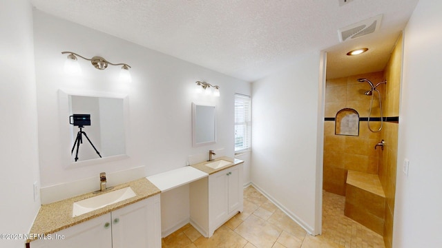 26 Sailfish Dr, Ponte Vedra Beach, FL 32082 - full bathroom with walk in shower, two vanities, tile patterned floors, a textured ceiling, and baseboards