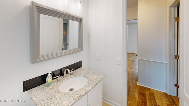26 Sailfish Dr, Ponte Vedra Beach, FL 32082 - bathroom with wood finished floors, vanity, and a wainscoted wall