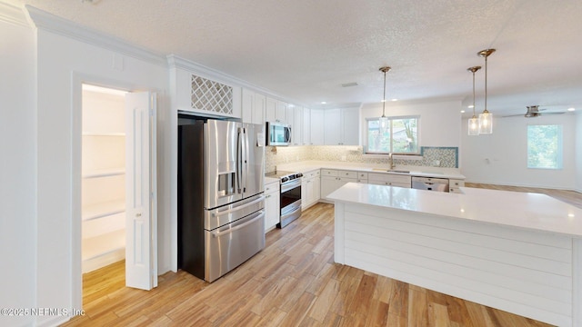 26 Sailfish Dr, Ponte Vedra Beach, FL 32082 - kitchen with appliances with stainless steel finishes, a sink, light countertops, backsplash, and a textured ceiling