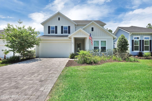 95 Farmers Branch Ave, Ponte Vedra, FL 32081 - view of front facade with board and batten siding, decorative driveway, a front lawn, and an attached garage