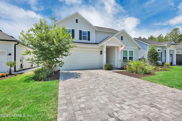 95 Farmers Branch Ave, Ponte Vedra, FL 32081 - view of front of home featuring board and batten siding, decorative driveway, a front yard, and a garage