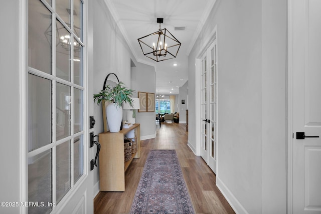 95 Farmers Branch Ave, Ponte Vedra, FL 32081 - entryway featuring french doors, a chandelier, wood finished floors, baseboards, and crown molding