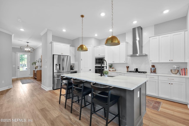 95 Farmers Branch Ave, Ponte Vedra, FL 32081 - kitchen with wall chimney range hood, appliances with stainless steel finishes, a sink, a breakfast bar, and a kitchen island with sink