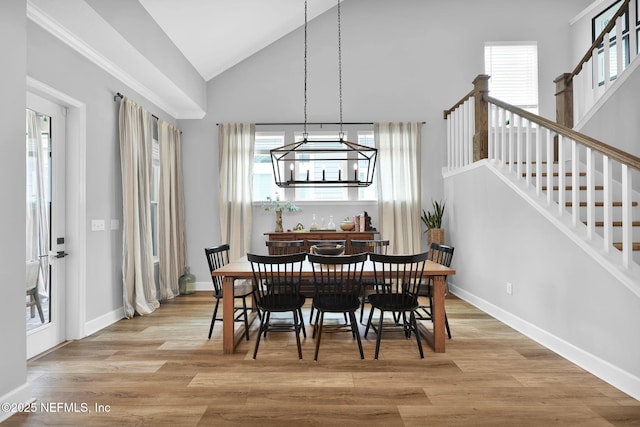 95 Farmers Branch Ave, Ponte Vedra, FL 32081 - dining space with a chandelier, plenty of natural light, wood finished floors, stairs, and high vaulted ceiling