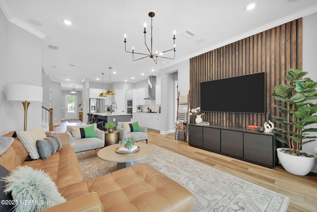 95 Farmers Branch Ave, Ponte Vedra, FL 32081 - living room featuring a chandelier, light wood finished floors, ornamental molding, and recessed lighting