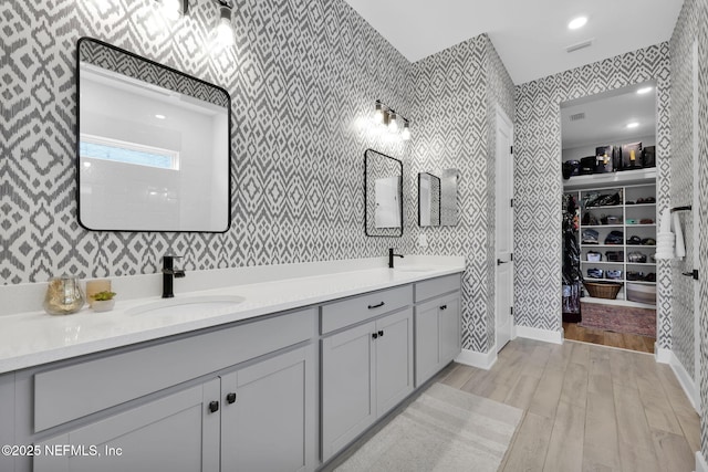 95 Farmers Branch Ave, Ponte Vedra, FL 32081 - bathroom featuring wallpapered walls, double vanity, wood finished floors, and a spacious closet