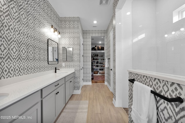 95 Farmers Branch Ave, Ponte Vedra, FL 32081 - bathroom with wallpapered walls, double vanity, hardwood / wood-style floors, and a walk in closet