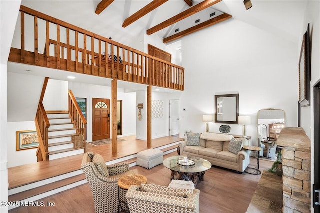 404 Camelia Trl, Saint Augustine, FL 32086 - living room featuring high vaulted ceiling, stairs, wood finished floors, and beam ceiling
