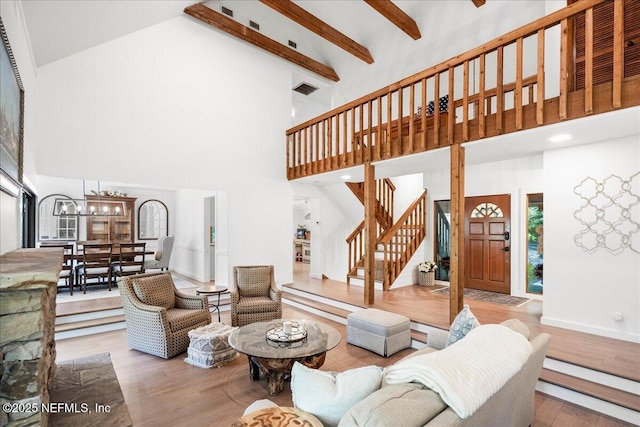 404 Camelia Trl, Saint Augustine, FL 32086 - living area with high vaulted ceiling, stairs, wood finished floors, a chandelier, and beam ceiling