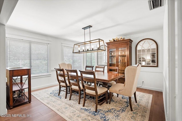 404 Camelia Trl, Saint Augustine, FL 32086 - dining room featuring wood finished floors, a chandelier, and baseboards