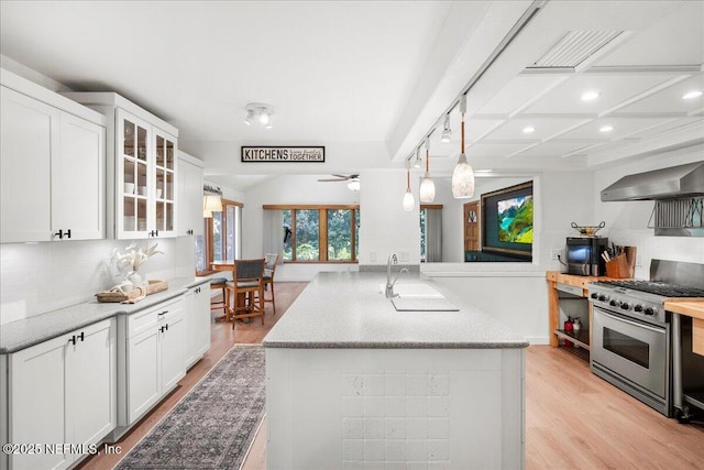 404 Camelia Trl, Saint Augustine, FL 32086 - kitchen with gas range, a sink, wall chimney exhaust hood, light wood-type flooring, and recessed lighting