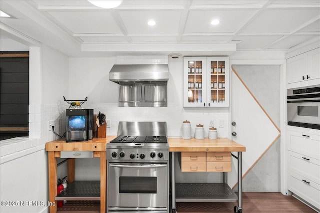 404 Camelia Trl, Saint Augustine, FL 32086 - kitchen featuring appliances with stainless steel finishes, wall chimney exhaust hood, backsplash, glass insert cabinets, and white cabinetry