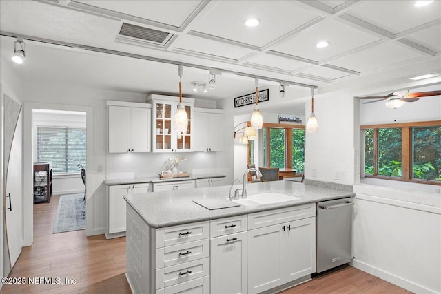 404 Camelia Trl, Saint Augustine, FL 32086 - kitchen featuring stainless steel dishwasher, a sink, light wood-style flooring, a peninsula, and white cabinets