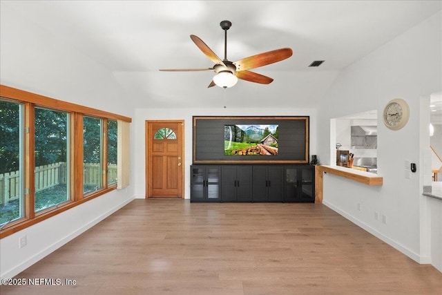 404 Camelia Trl, Saint Augustine, FL 32086 - unfurnished living room featuring vaulted ceiling, a ceiling fan, wood finished floors, and baseboards