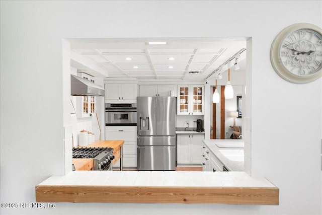 404 Camelia Trl, Saint Augustine, FL 32086 - kitchen with stainless steel appliances, coffered ceiling, range hood, recessed lighting, and glass insert cabinets