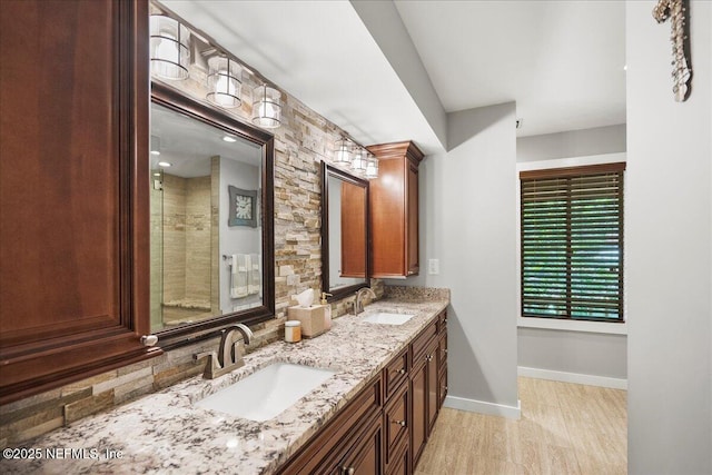 404 Camelia Trl, Saint Augustine, FL 32086 - full bathroom featuring double vanity, baseboards, a tile shower, and wood finished floors