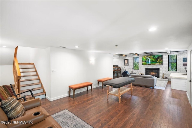 404 Camelia Trl, Saint Augustine, FL 32086 - living area featuring a brick fireplace, dark wood finished floors, stairs, baseboards, and recessed lighting