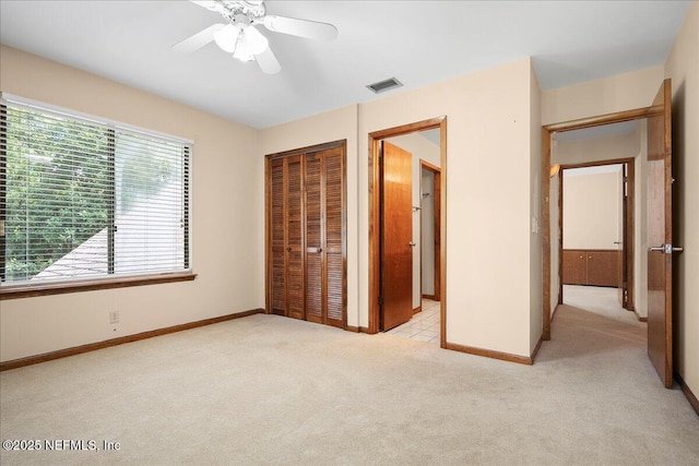 404 Camelia Trl, Saint Augustine, FL 32086 - unfurnished bedroom featuring light carpet, a closet, baseboards, and a ceiling fan