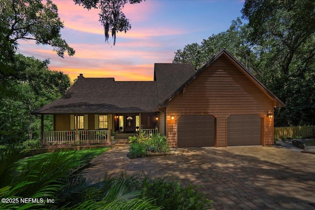 404 Camelia Trl, Saint Augustine, FL 32086 - view of front of house with a porch, an attached garage, decorative driveway, and roof with shingles