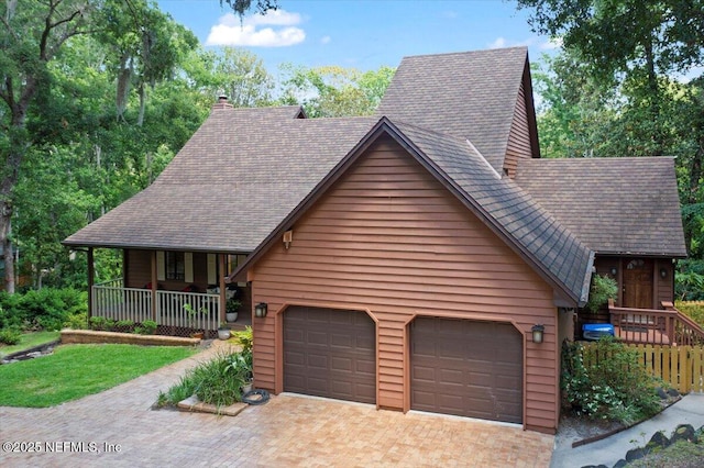 404 Camelia Trl, Saint Augustine, FL 32086 - chalet / cabin featuring decorative driveway, roof with shingles, covered porch, and a chimney