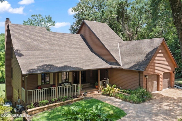404 Camelia Trl, Saint Augustine, FL 32086 - view of front facade featuring a porch, a chimney, and roof with shingles